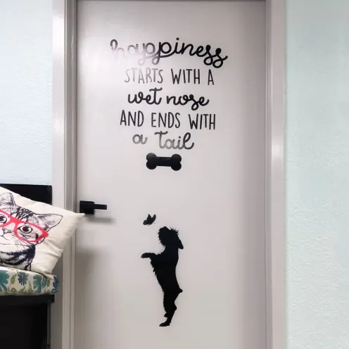 "Happiness starts with a wet nose and ends with a tail" quote on a door
